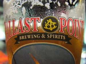 A Ballast Point branded pint glass in extreme close-up